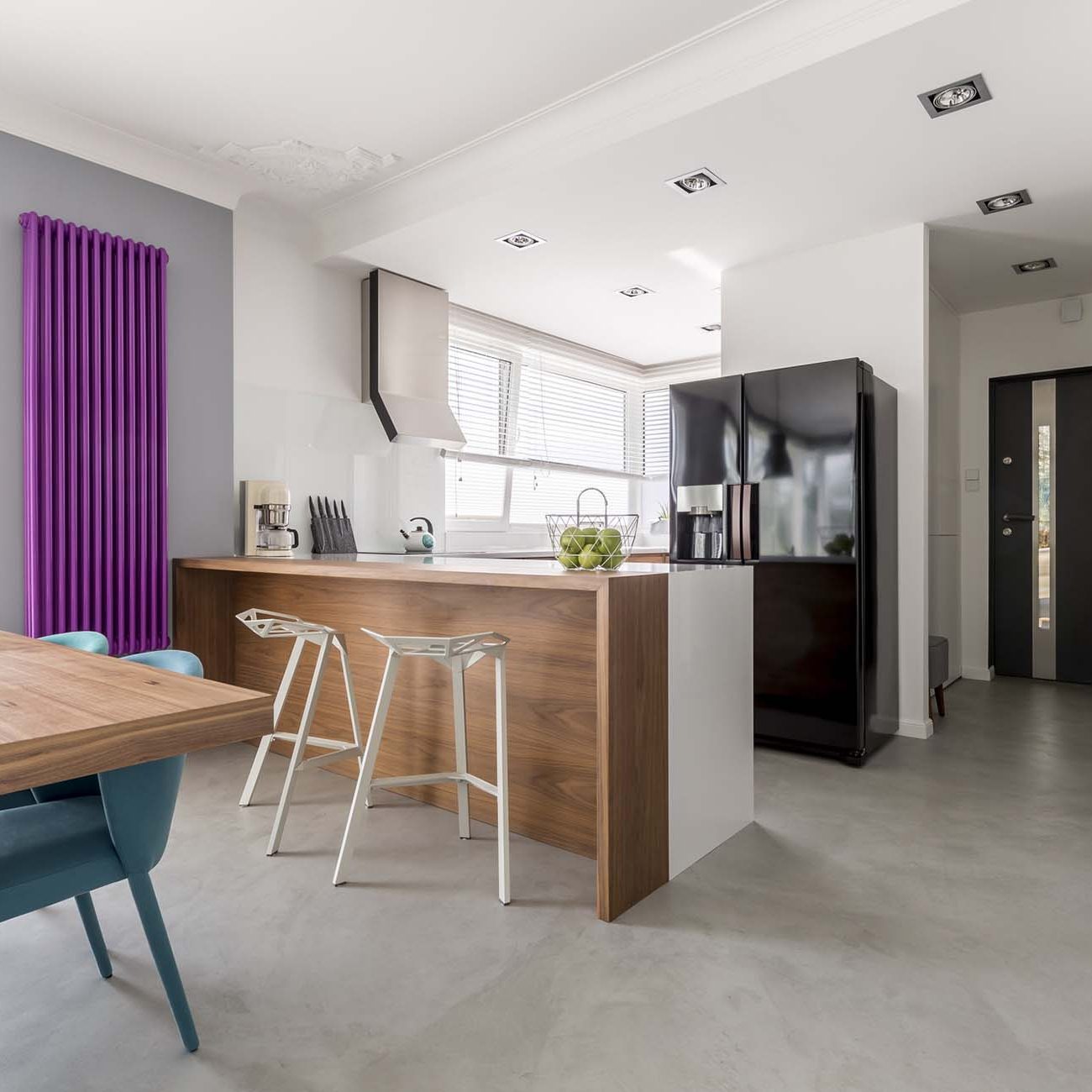 Dining room, kitchen and entrance in contemporary family house with minimalist gray design, colorful accents and wooden furniture